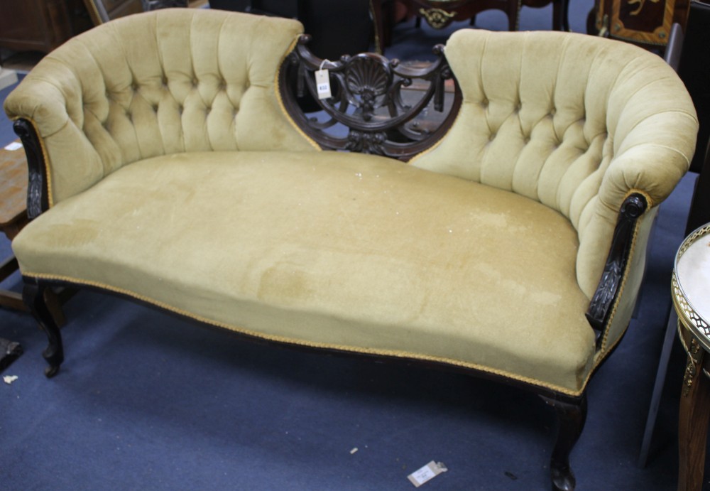 An Edwardian carved and ebonised three-seater settee, with button back and original ceramics castors, W.155cm D.73cm H.76cm